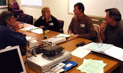 Pictured from the left are Mel Ginsberg, Kate Sullivan, Jeffrey Mann, and Jeff Johnson, teachers from Ashland School District’s special education program, discussing new and innovative ways to provide assistive technology to students with special needs.
