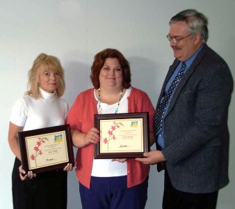 Jann and Debbie receive their award from Jay